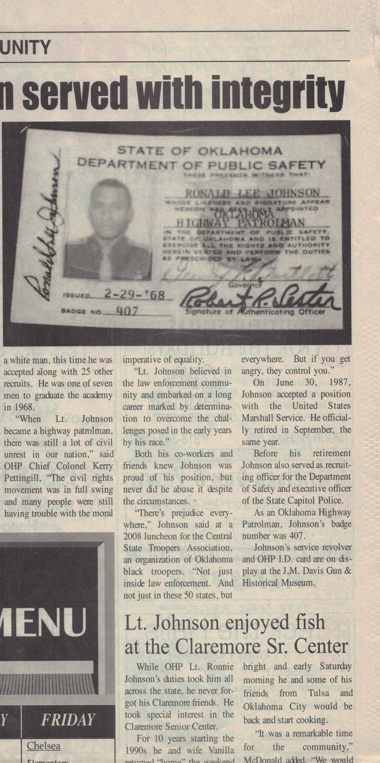 Three columns of article text under image of ID card and partial article title.